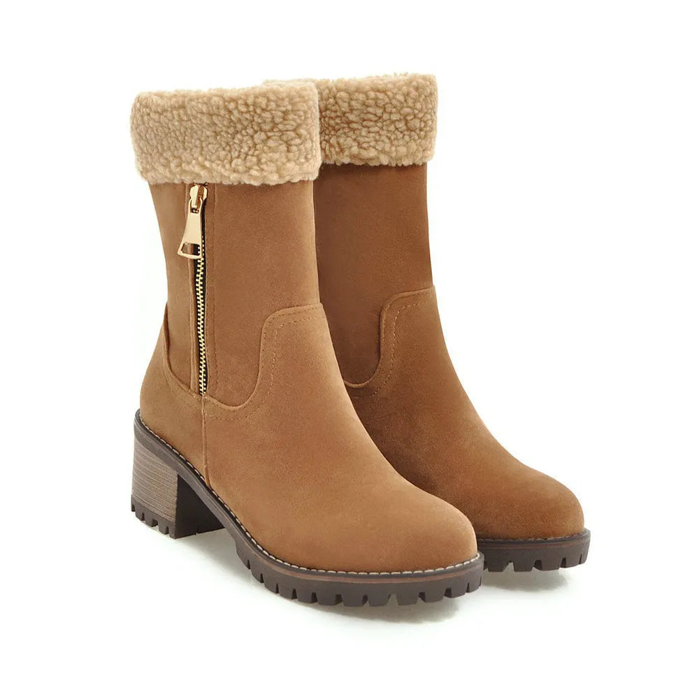 A pair of snow boots with a rubber sole and plush lining on a winter background.