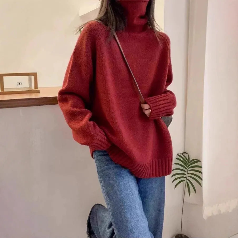 Women's thick loose-fit turtleneck sweater with curling pile collar in red, camel, grey, or black.