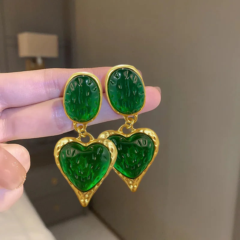Pleated oval heart stud earrings in alloy showing four colour options