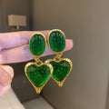 Pleated oval heart stud earrings in alloy showing four colour options