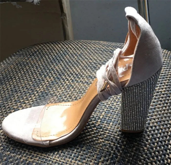 Black and gold plastic women's platform sandals with a pointed toe