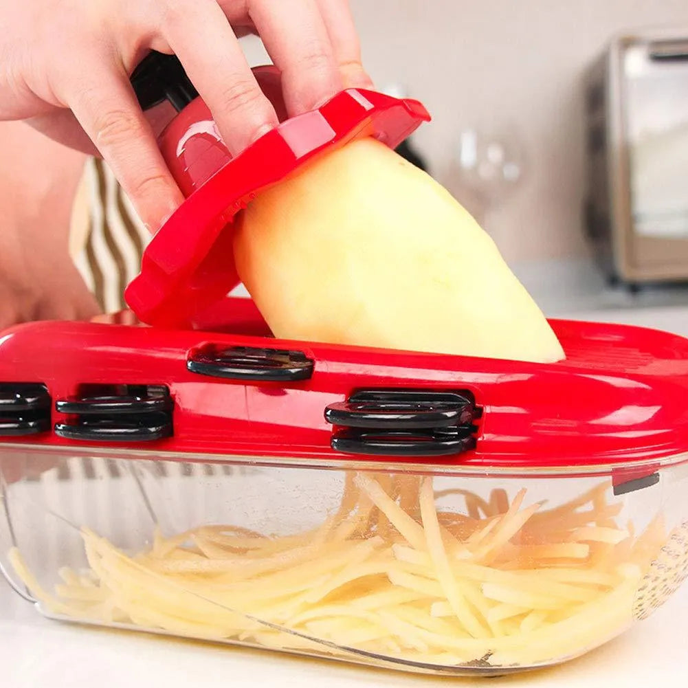 Red multi-function vegetable cutter with seven stainless steel blades, plastic container, and safety hand guard