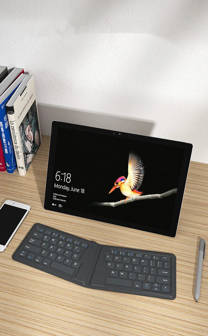 Folding Bluetooth keyboard with 64 keys X architecture ABS material USB charging for iPad tablet phone
