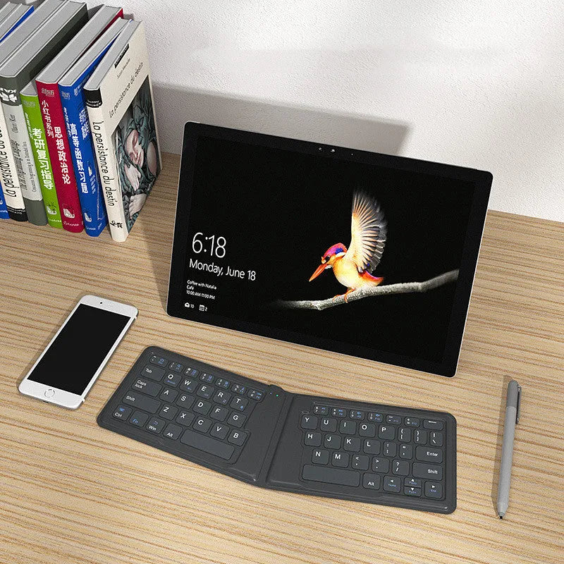 Folding Bluetooth keyboard with 64 keys X architecture ABS material USB charging for iPad tablet phone