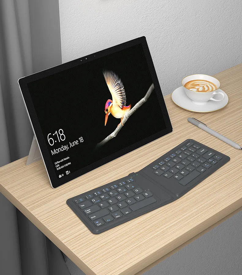 Folding Bluetooth keyboard with 64 keys X architecture ABS material USB charging for iPad tablet phone