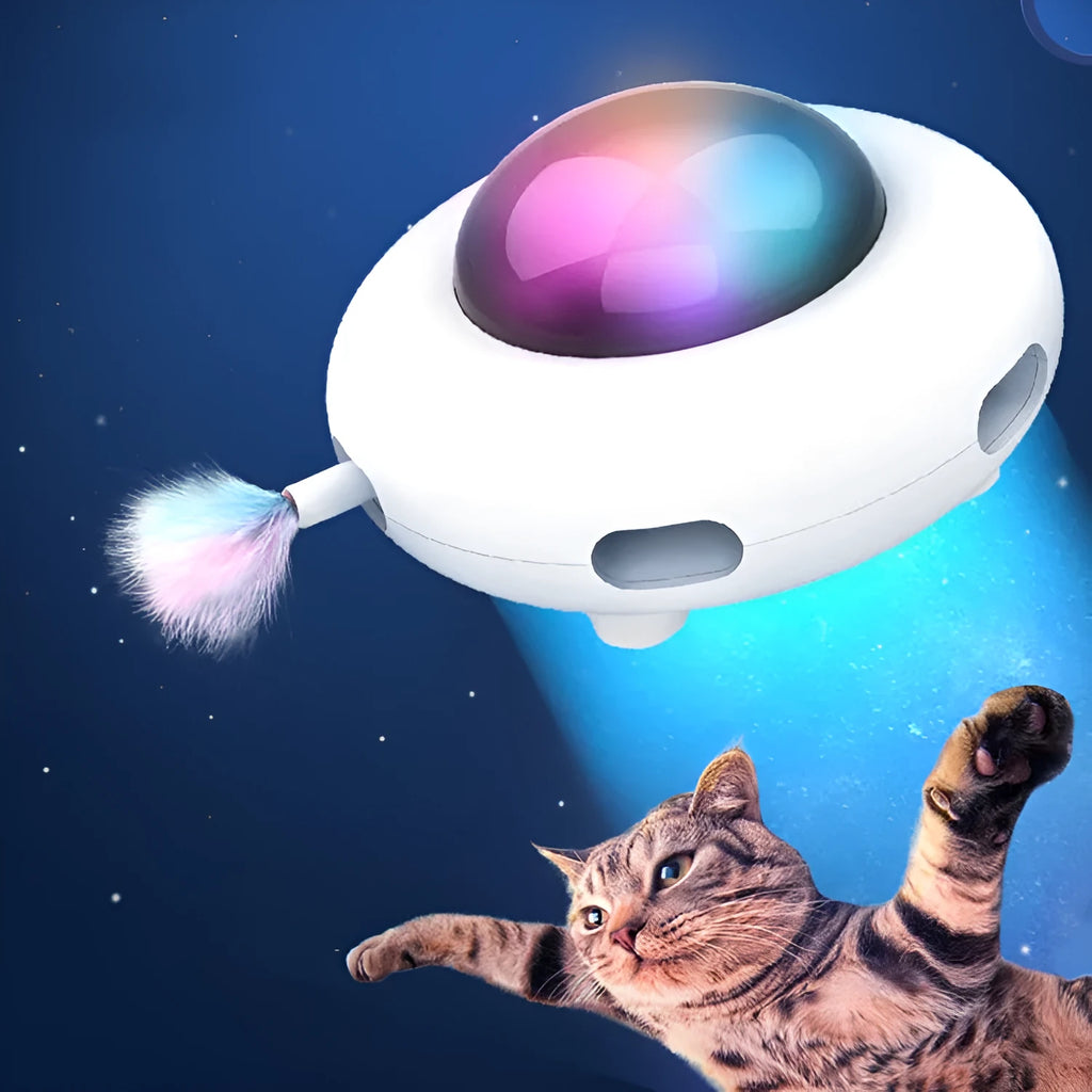 White UFO electric cat turntable toy with feather accessories on floor