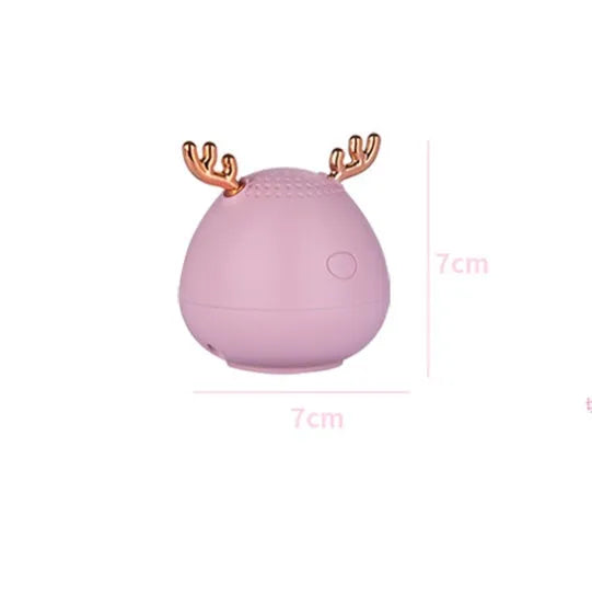 Small green portable Bluetooth speaker with USB charging port on a white background.
