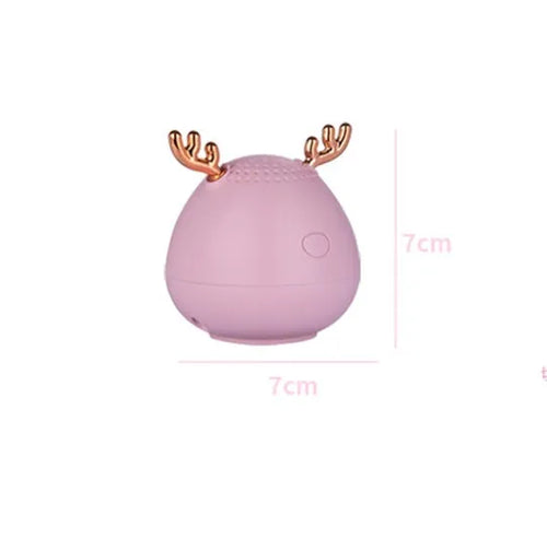 Small green portable Bluetooth speaker with USB charging port on a white background.