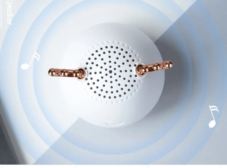 Small green portable Bluetooth speaker with USB charging port on a white background.