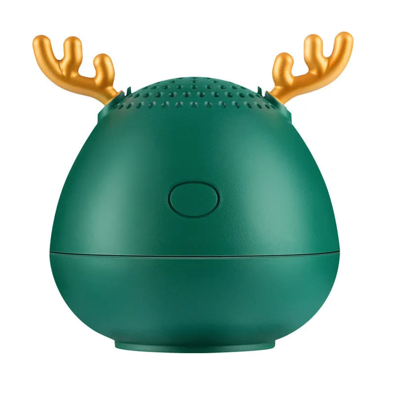 Small green portable Bluetooth speaker with USB charging port on a white background.