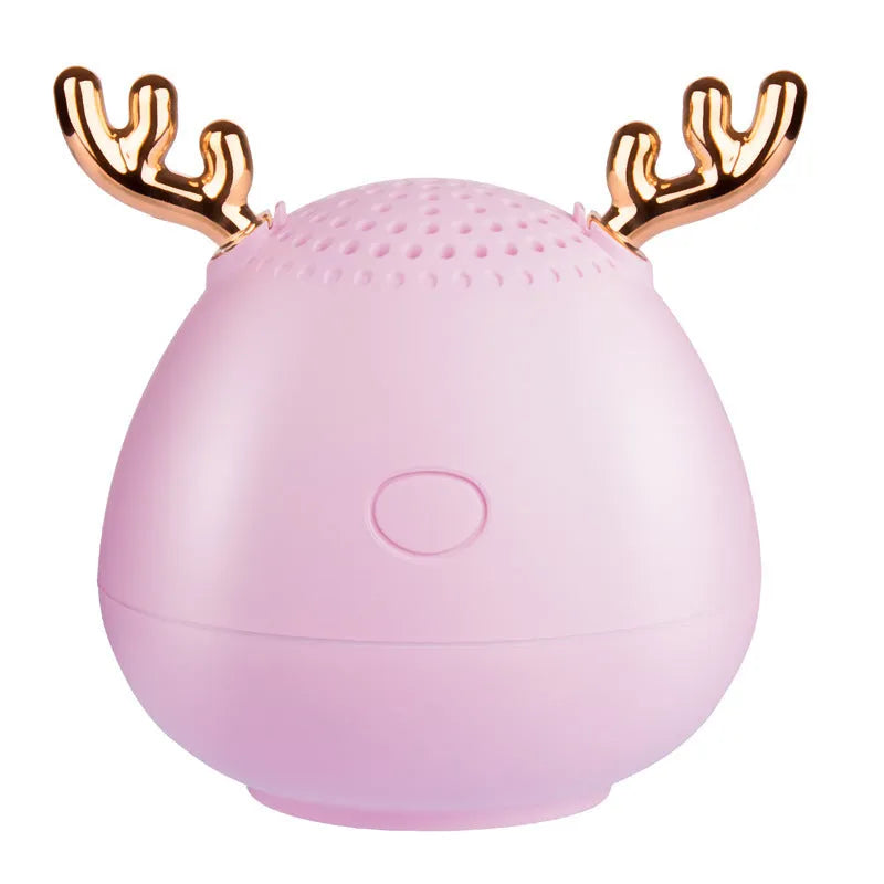 Small green portable Bluetooth speaker with USB charging port on a white background.
