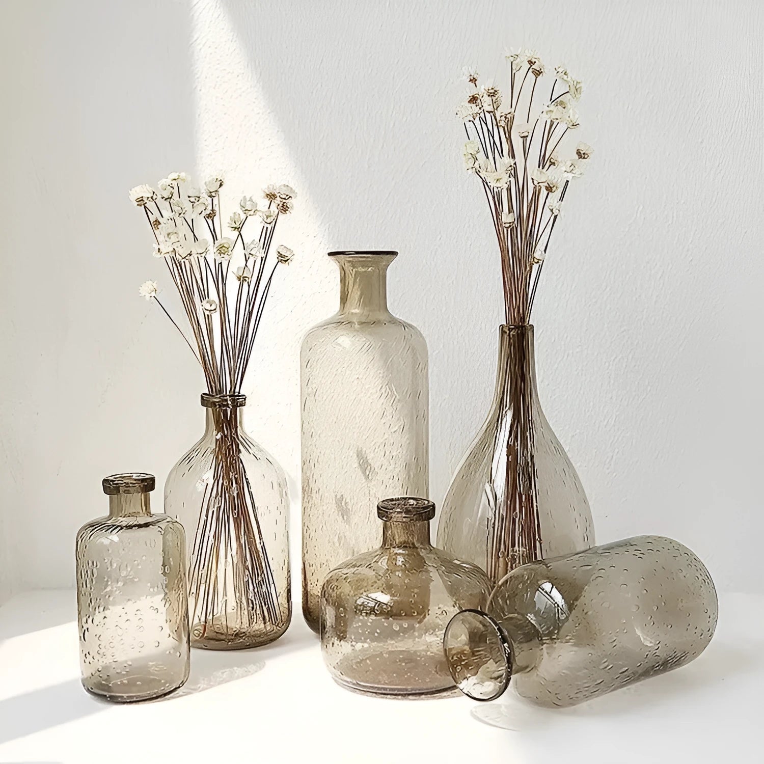 A grey geometric bubble glass decorative vase with a textured stained glass surface.