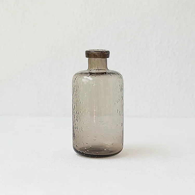 A grey geometric bubble glass decorative vase with a textured stained glass surface.