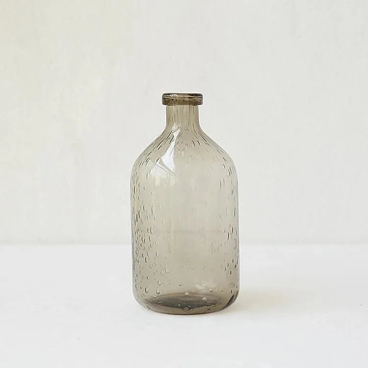 A grey geometric bubble glass decorative vase with a textured stained glass surface.