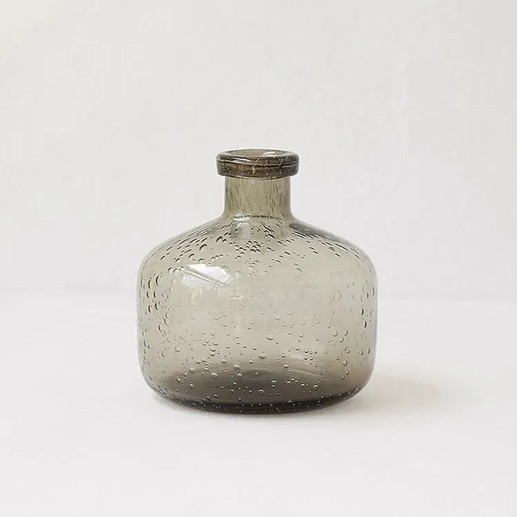 A grey geometric bubble glass decorative vase with a textured stained glass surface.