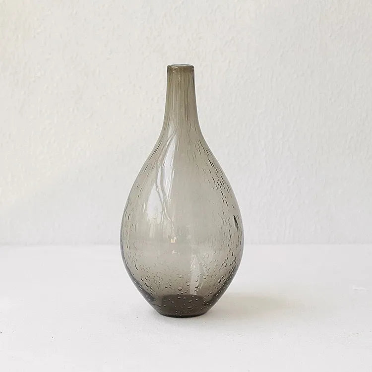 A grey geometric bubble glass decorative vase with a textured stained glass surface.