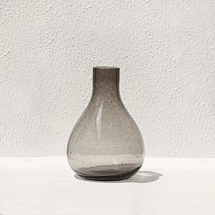 A grey geometric bubble glass decorative vase with a textured stained glass surface.