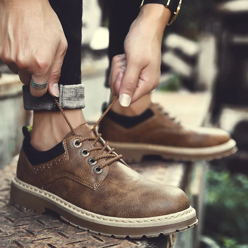 Men's black casual shoes with lace-up front and round toe design on rubber sole