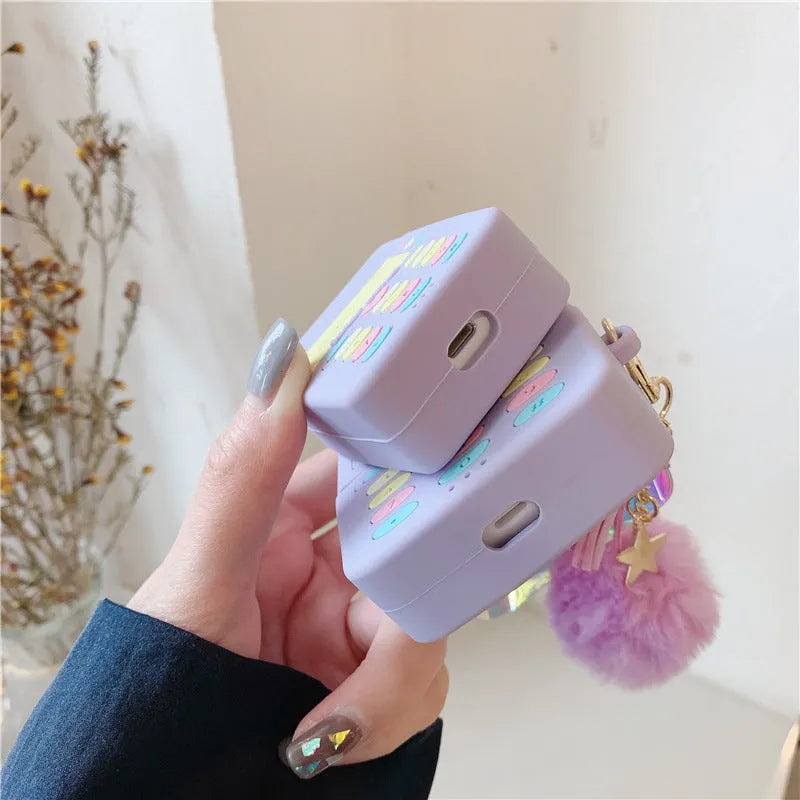 Purple silicone case for Apple AirPods with clamshell closure and fur ball pendant