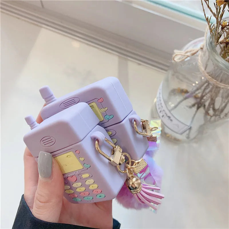 Purple silicone case for Apple AirPods with clamshell closure and fur ball pendant