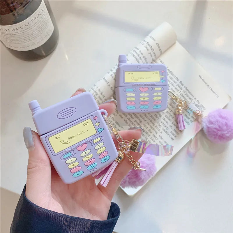 Purple silicone case for Apple AirPods with clamshell closure and fur ball pendant