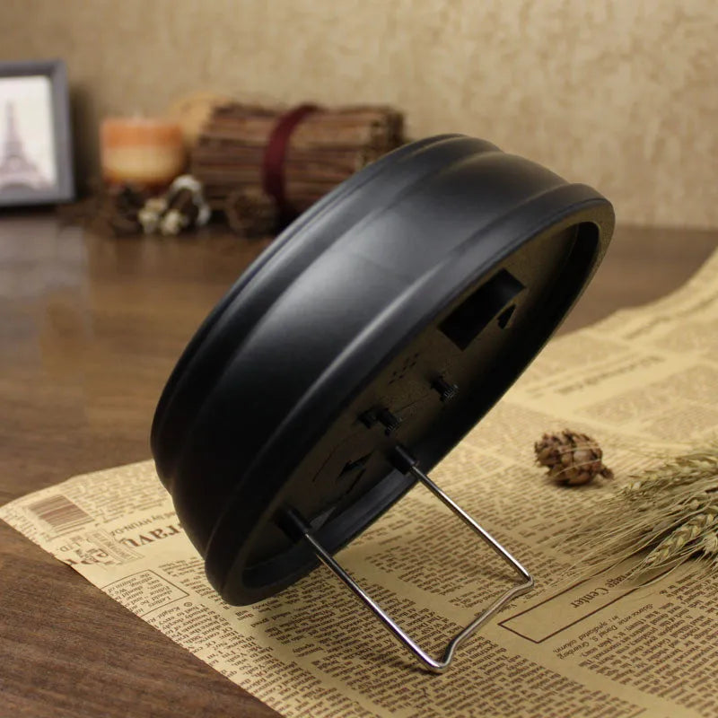 Round retro European desk clock with a 6-inch dial on a wooden surface.