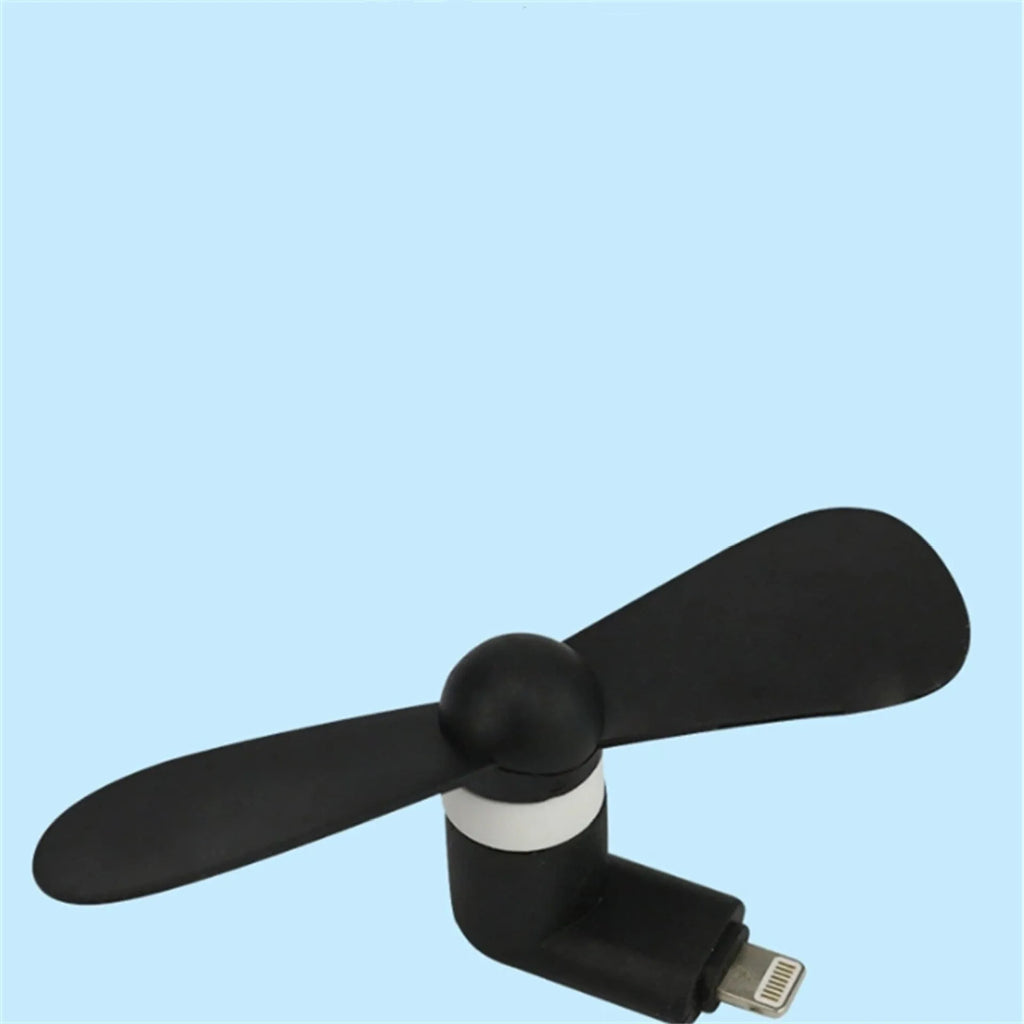 White portable mini fan with plastic blades and rotary switch attached to a mobile phone.