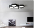 Geometric shaped iron LED ceiling light with remote control on a white ceiling