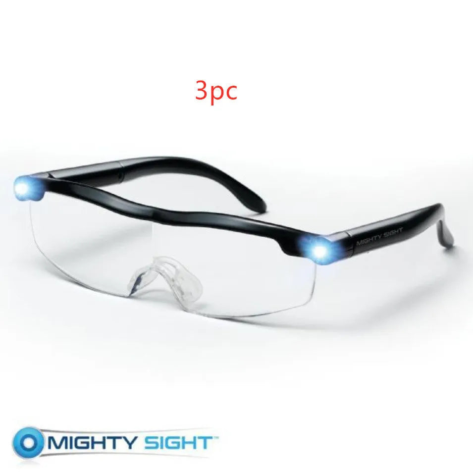 Transparent black USB LED light reading glasses on a table, showing the built-in light and frame.
