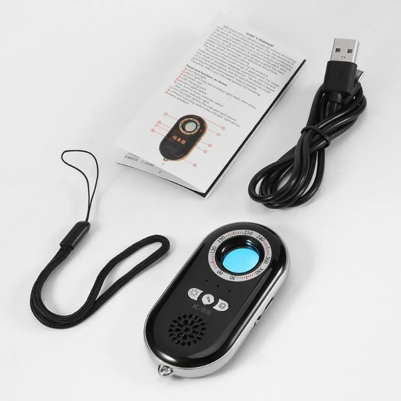 Compact black wireless security alarm detector with USB charging port, shown next to a ruler for scale.
