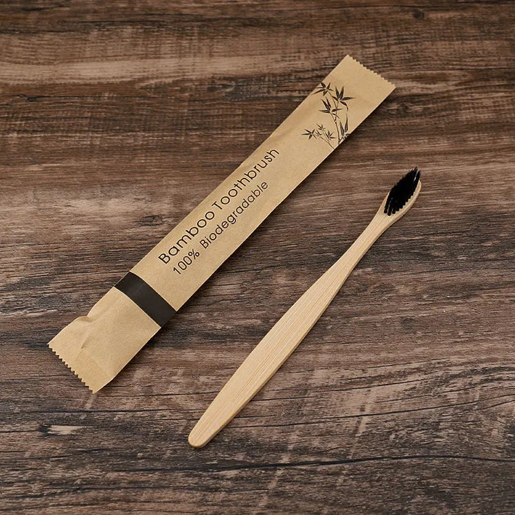 Set of ten bamboo toothbrushes with charcoal-infused bristles in assorted colours on a white background.