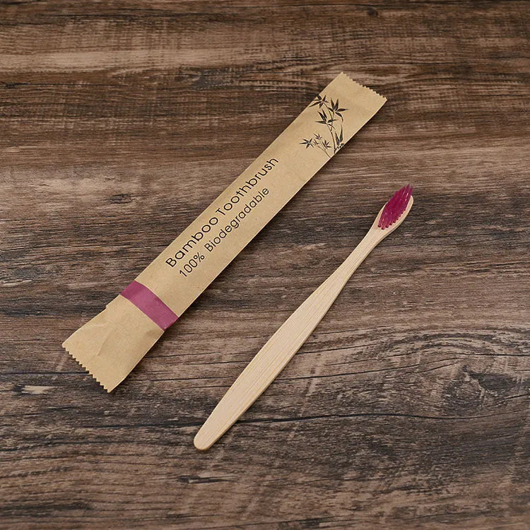 Set of ten bamboo toothbrushes with charcoal-infused bristles in assorted colours on a white background.