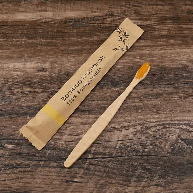 Set of ten bamboo toothbrushes with charcoal-infused bristles in assorted colours on a white background.