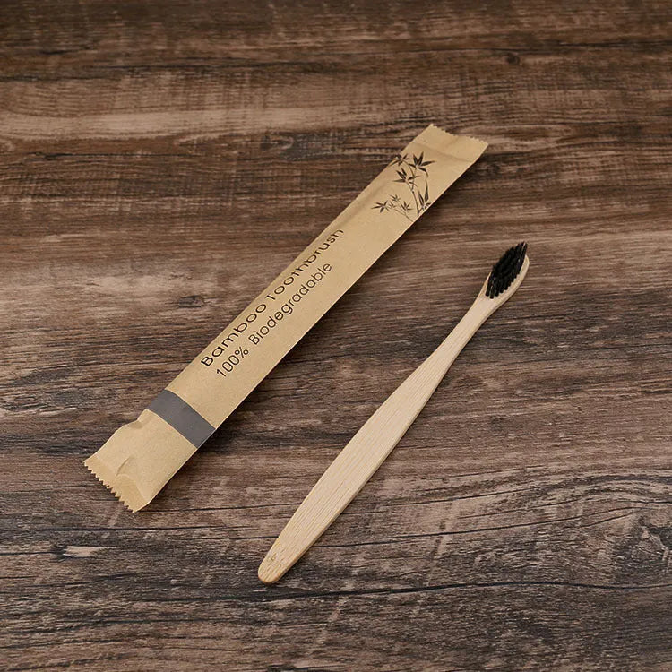 Set of ten bamboo toothbrushes with charcoal-infused bristles in assorted colours on a white background.