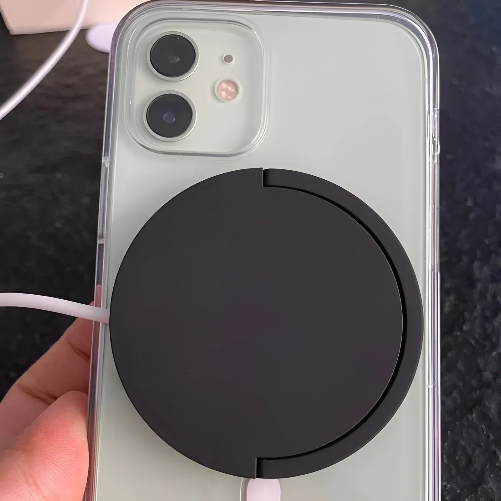 Black magnetic wireless charging bracket holding mobile phone with TYPE-C cable connection