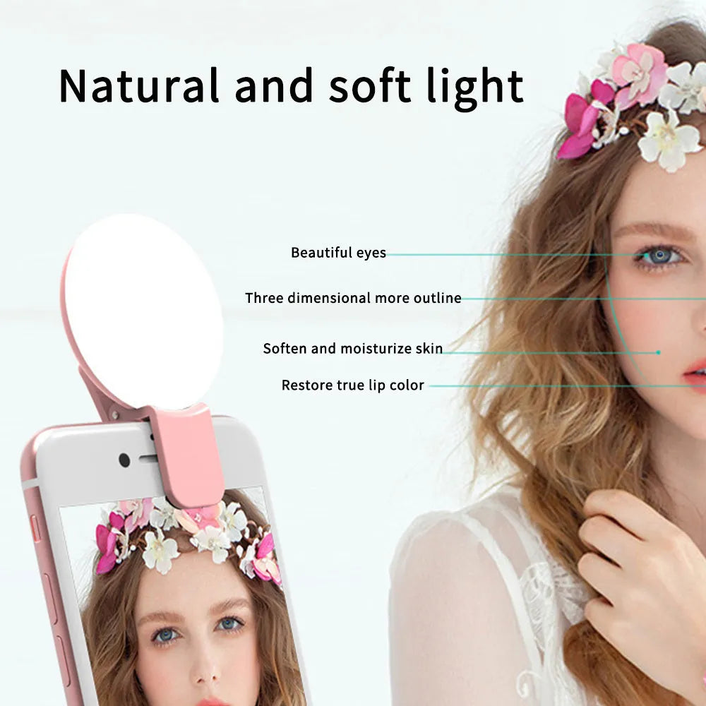 Mini round clip-on LED fill light attached to mobile phone for selfie photography