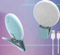 Mini round clip-on LED fill light attached to mobile phone for selfie photography