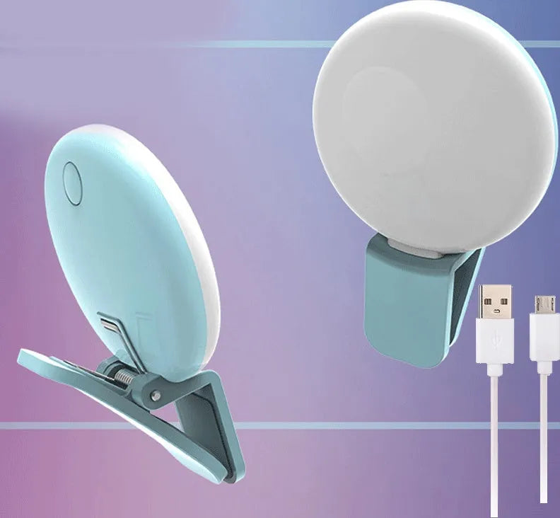 Mini round clip-on LED fill light attached to mobile phone for selfie photography