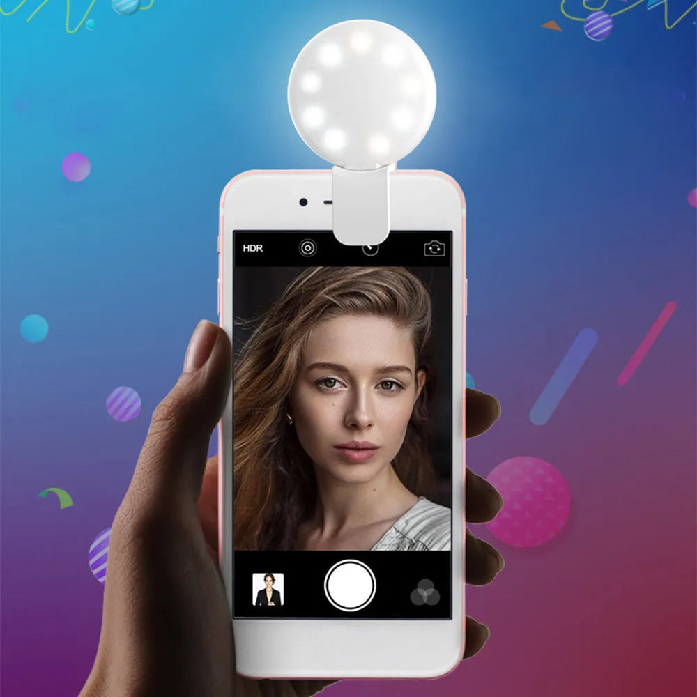 Mini round clip-on LED fill light attached to mobile phone for selfie photography
