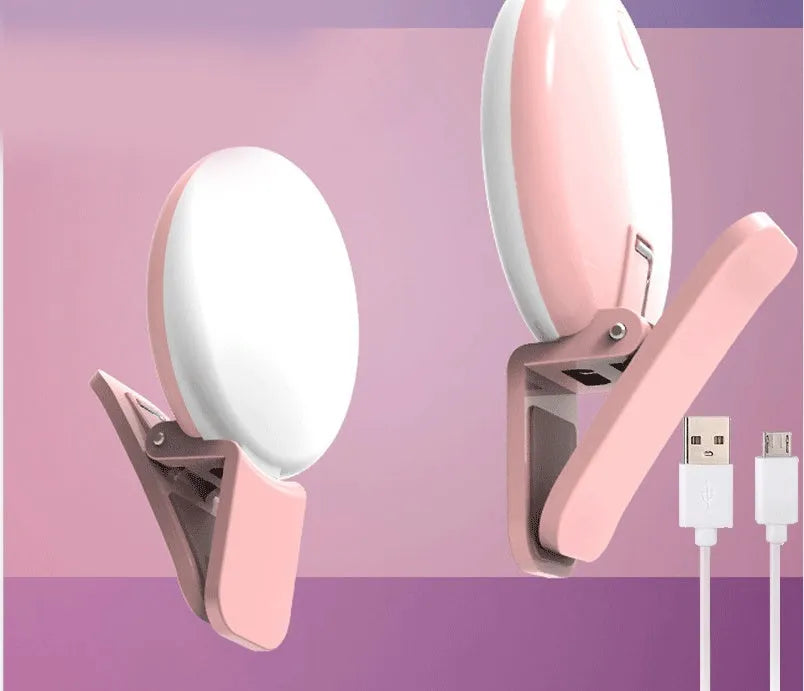 Mini round clip-on LED fill light attached to mobile phone for selfie photography