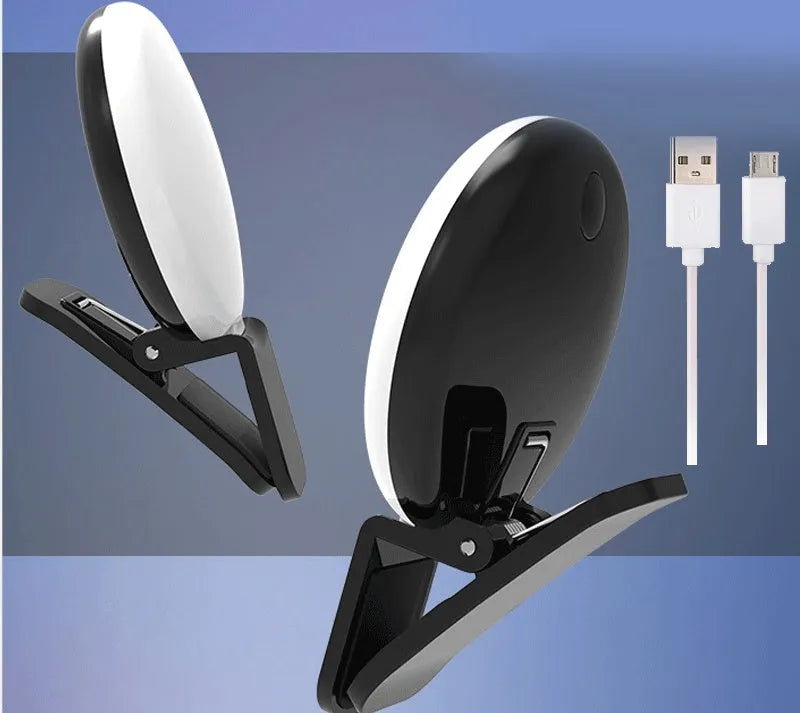 Mini round clip-on LED fill light attached to mobile phone for selfie photography