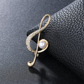 Unisex temperament corsage brooch pin with alloy inlaid artificial gem stone musical note design