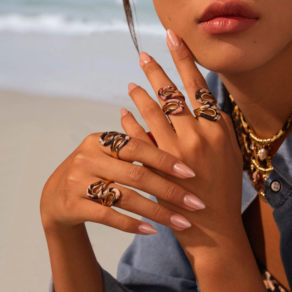 Stainless steel open mouth ring with leopard print in geometric shape on a hand.