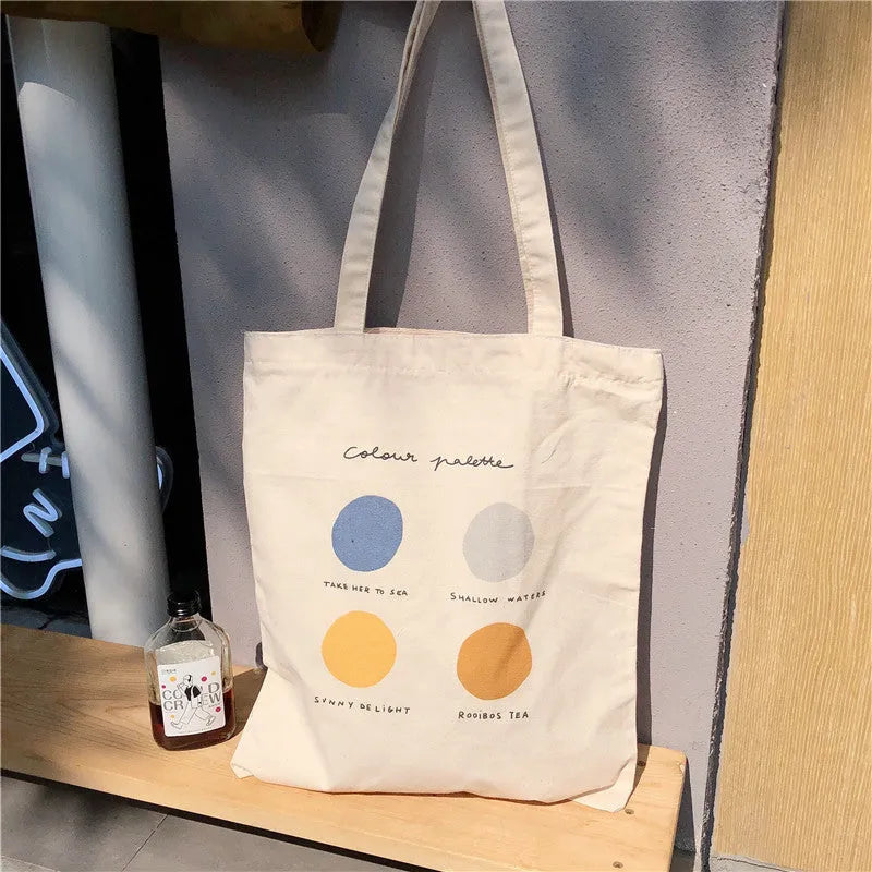 Women's canvas tote shoulder bag with geometric pattern in orange colour showing zip closure and double straps