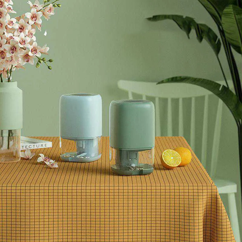 Portable mini dehumidifier in blue colour with 0.7L water tank and international power plugs.