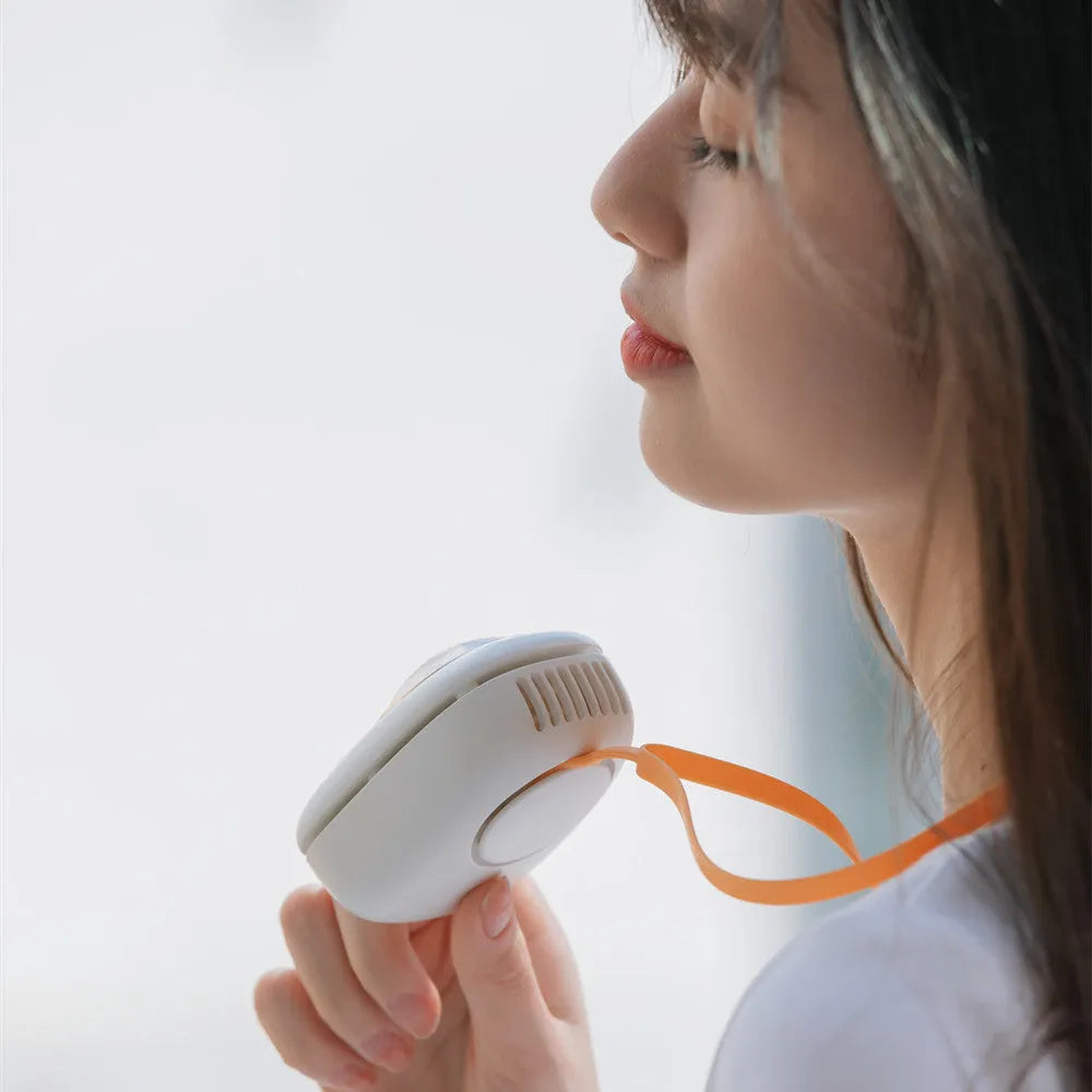 White portable hanging neck fan with USB charging port and mechanical speed controls
