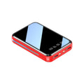 Compact white 20000mAh power bank with digital display showing battery percentage.
