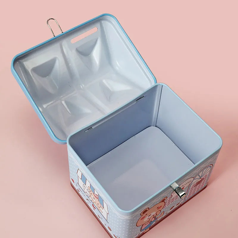 Blue house-shaped tinplate piggy bank for coin storage on wooden desk