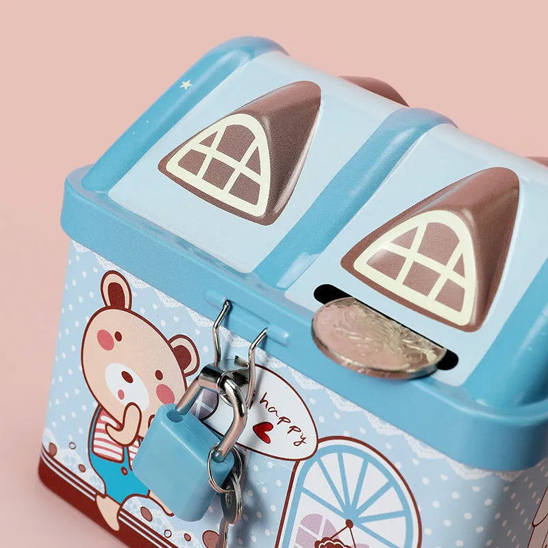 Blue house-shaped tinplate piggy bank for coin storage on wooden desk