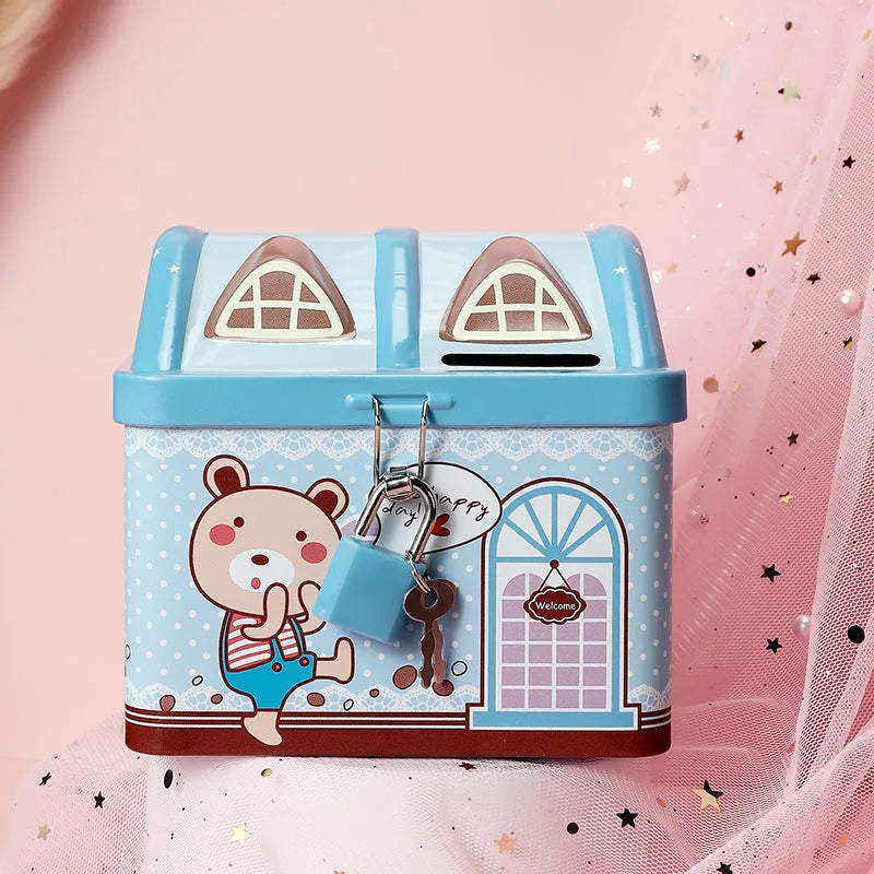 Blue house-shaped tinplate piggy bank for coin storage on wooden desk